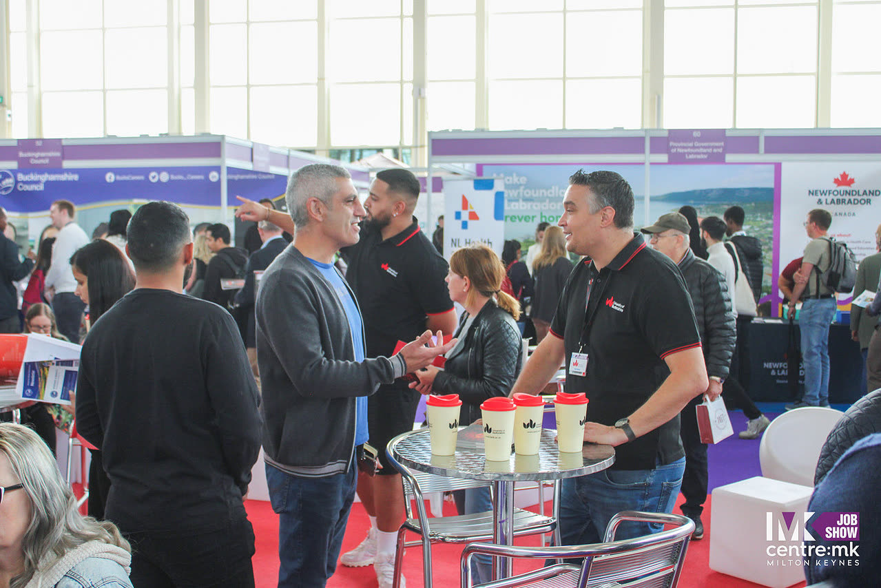 An employer and candidate in conversation at a stand at the MK Job Show